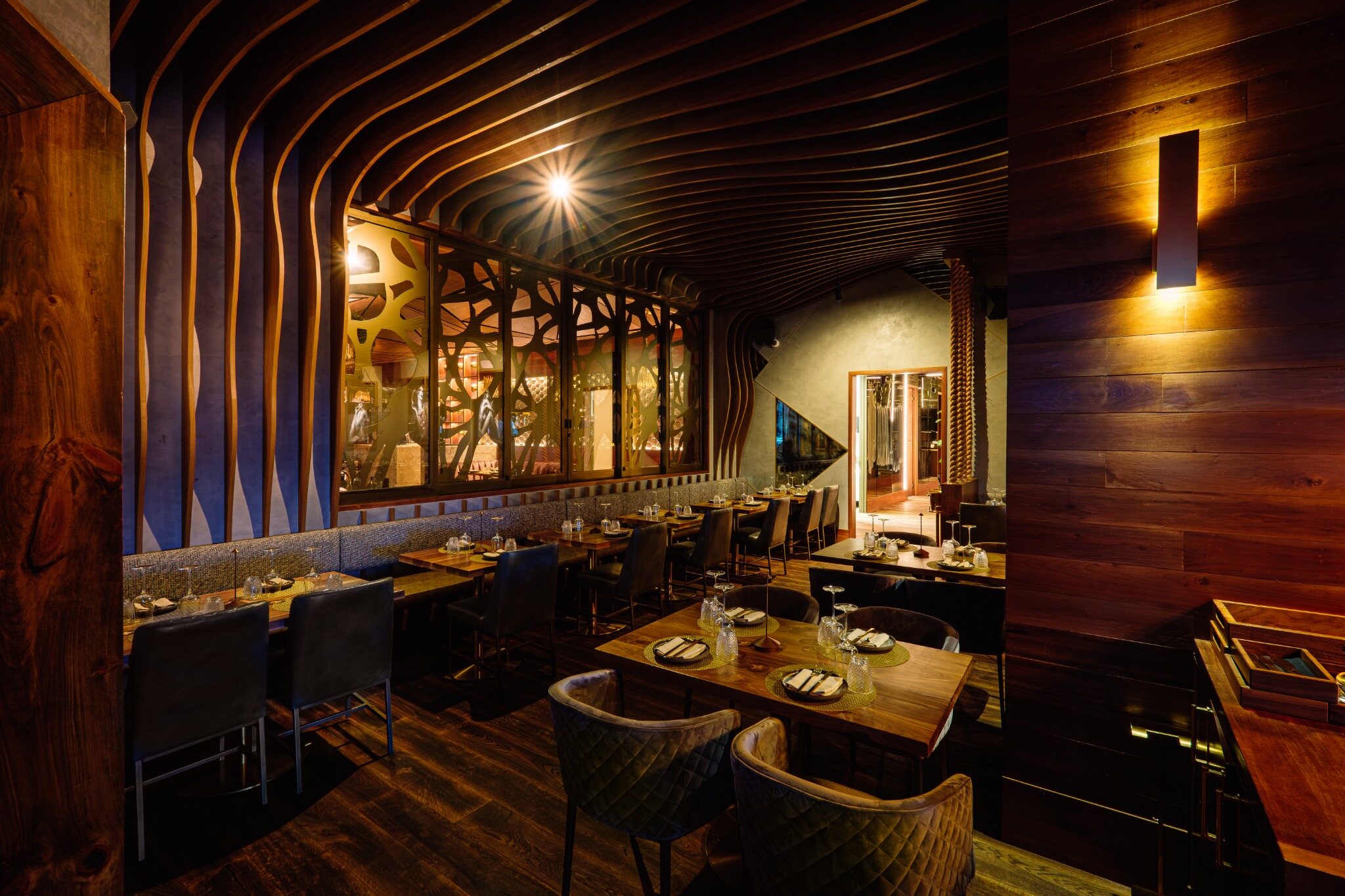 Completed curved wood slat ceiling at Toca Madera